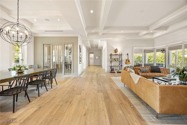 living room with beam ceiling, plenty of natural light, a notable chandelier, and coffered ceiling