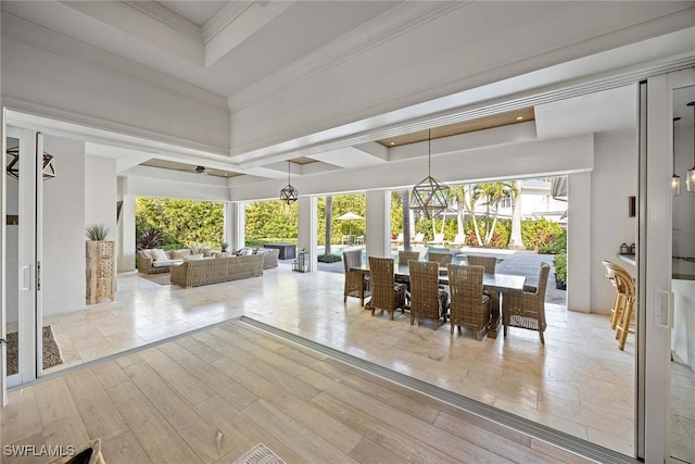 sunroom / solarium featuring a tray ceiling