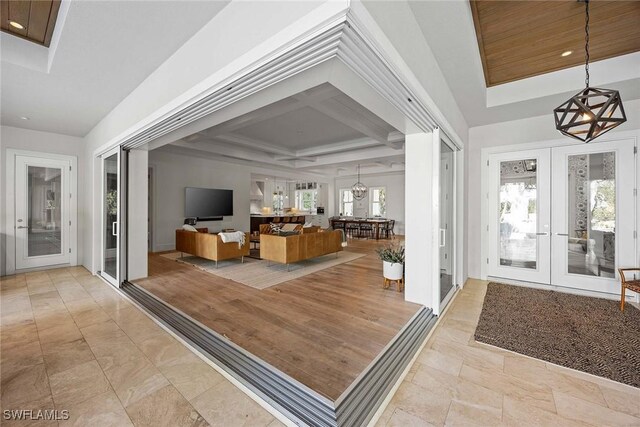 661 6th Ave N, Naples, FL 34102 - foyer with french doors, a chandelier, coffered ceiling, and beam ceiling