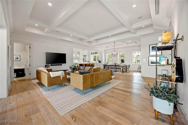 living room featuring beamed ceiling, light hardwood / wood-style floors, coffered ceiling, and ornamental molding