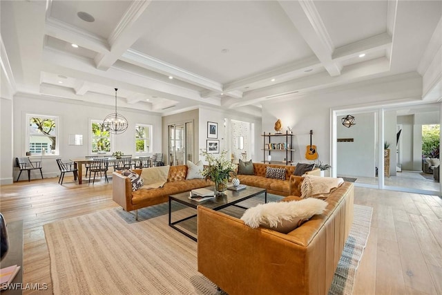 living room with light hardwood / wood-style flooring, beamed ceiling, coffered ceiling, and a notable chandelier