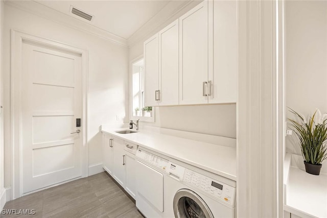 washroom featuring cabinets, crown molding, and sink