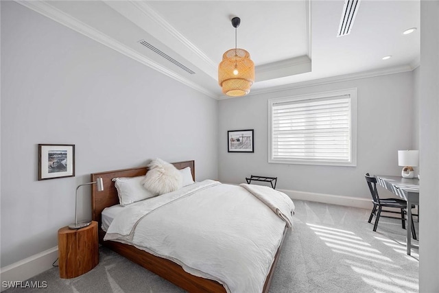 carpeted bedroom featuring a tray ceiling and crown molding