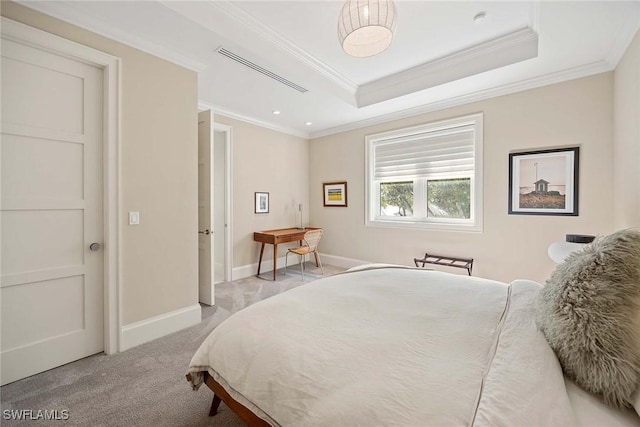 carpeted bedroom featuring a tray ceiling and crown molding