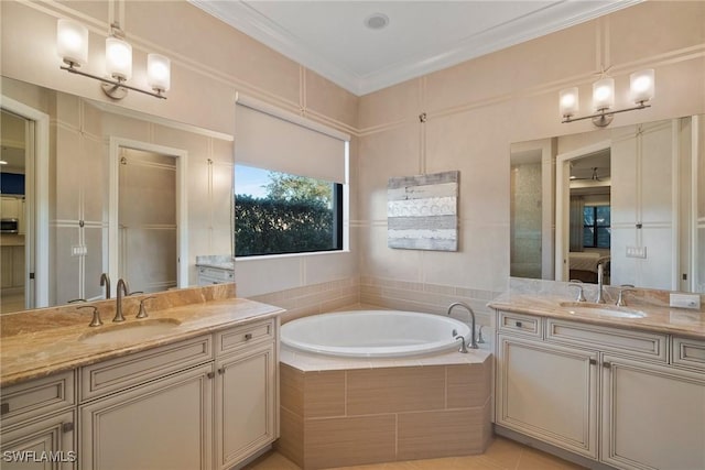 bathroom with tile patterned floors, vanity, ornamental molding, and tiled bath