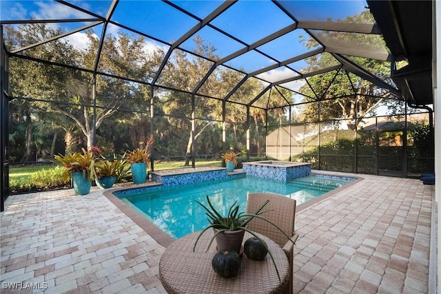 view of swimming pool featuring an in ground hot tub, glass enclosure, and a patio area