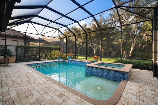 view of pool with a lanai, an in ground hot tub, and a patio