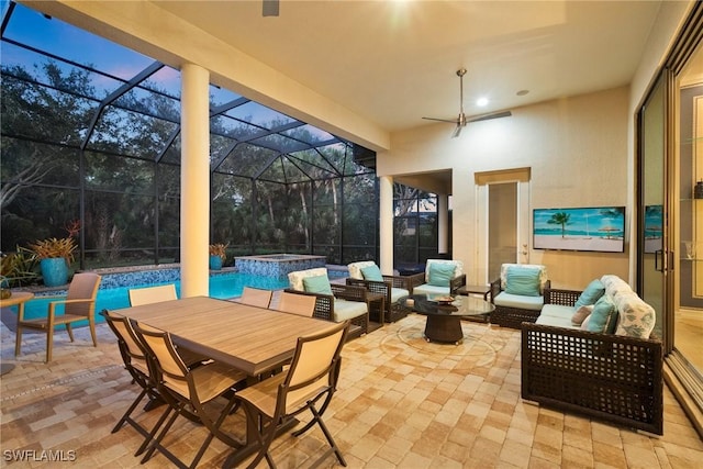 patio terrace at dusk featuring outdoor lounge area, a swimming pool with hot tub, and glass enclosure