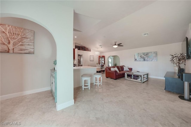 living room with ceiling fan and lofted ceiling