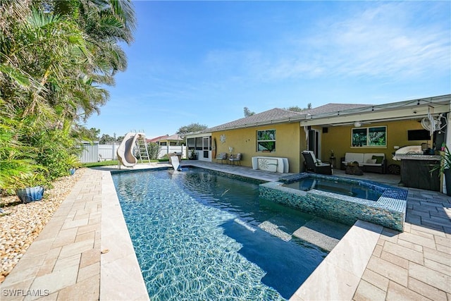 view of swimming pool featuring an in ground hot tub, a patio area, and a water slide