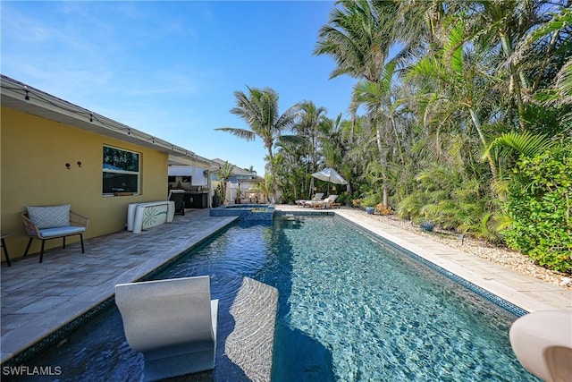 view of swimming pool featuring an in ground hot tub and a patio