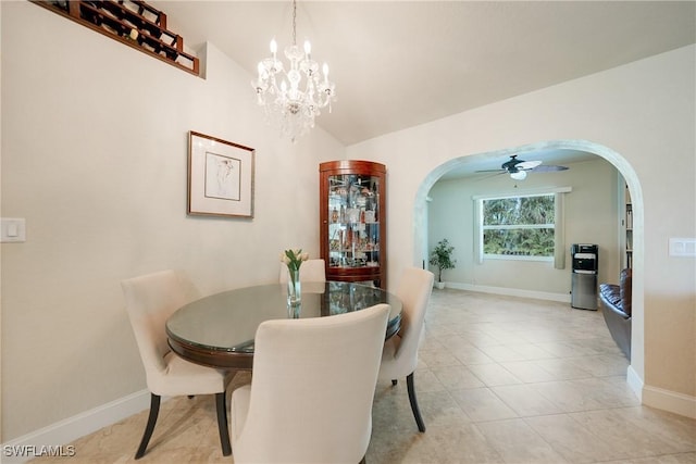 dining room featuring ceiling fan with notable chandelier, lofted ceiling, and light tile patterned floors