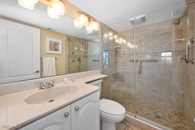 bathroom with walk in shower, vanity, and toilet