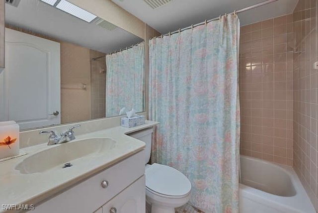 full bathroom featuring a skylight, shower / bath combo, vanity, and toilet