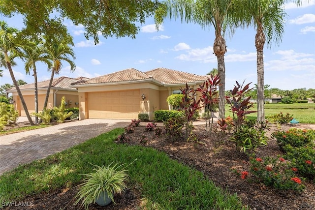 mediterranean / spanish-style home with a garage