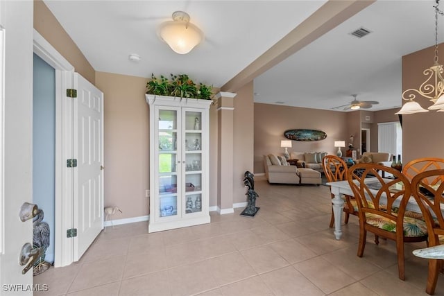 tiled dining room featuring ceiling fan