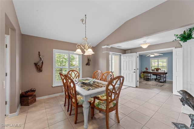 tiled dining space featuring lofted ceiling and a notable chandelier