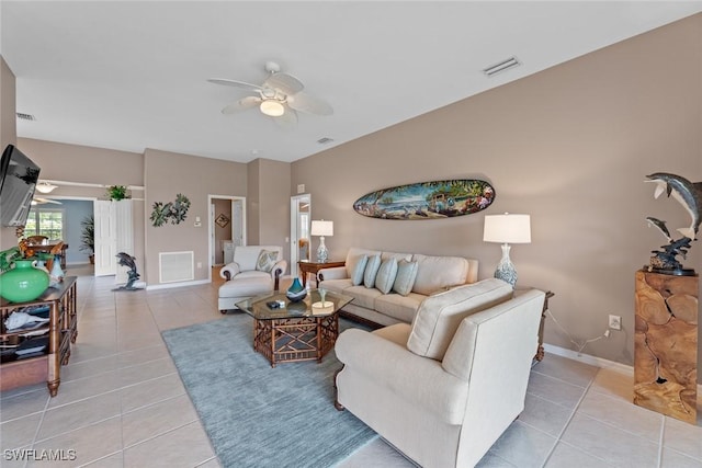 tiled living room featuring ceiling fan