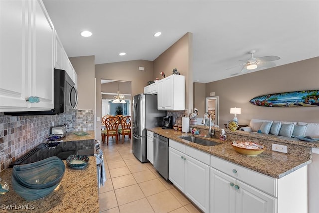 kitchen featuring appliances with stainless steel finishes, dark stone counters, ceiling fan, sink, and white cabinetry