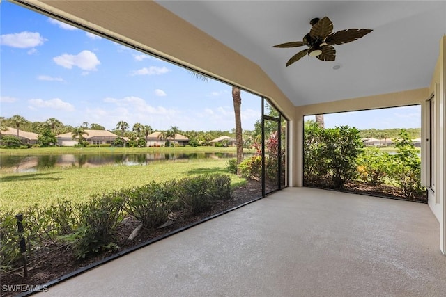 unfurnished sunroom with a water view, ceiling fan, and lofted ceiling