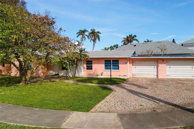 ranch-style house with a garage and a front yard