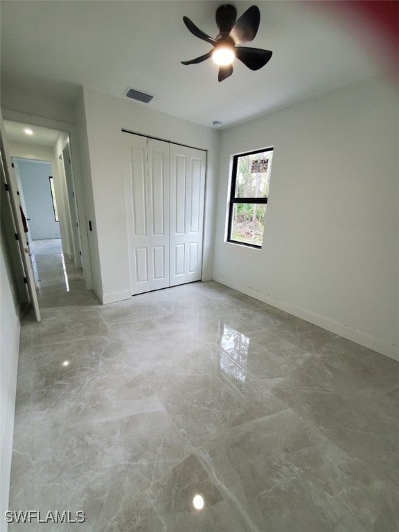 unfurnished bedroom featuring a closet and ceiling fan