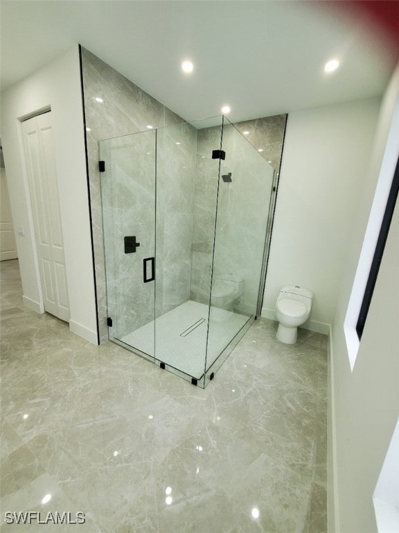 bathroom featuring an enclosed shower and toilet