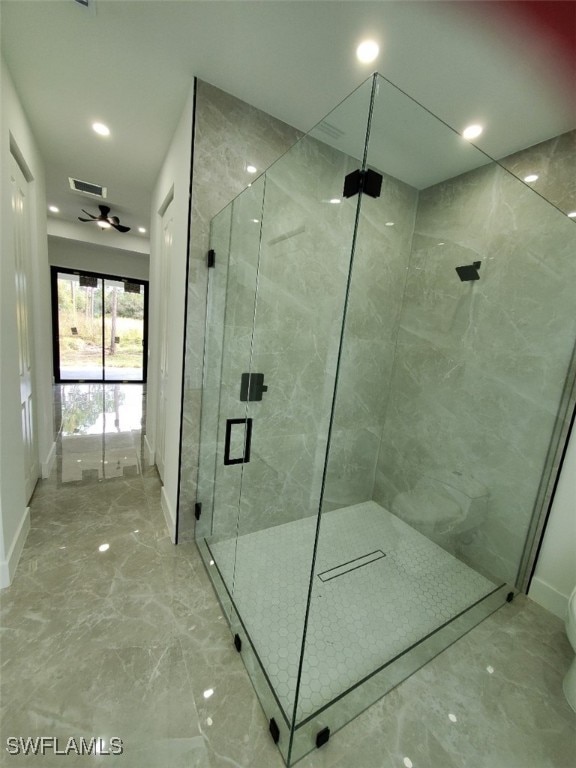 bathroom with ceiling fan and an enclosed shower