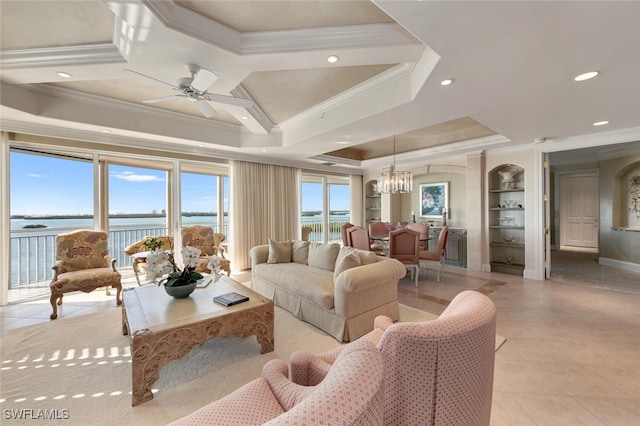 living room featuring a tray ceiling, light tile patterned floors, recessed lighting, ornamental molding, and ceiling fan with notable chandelier