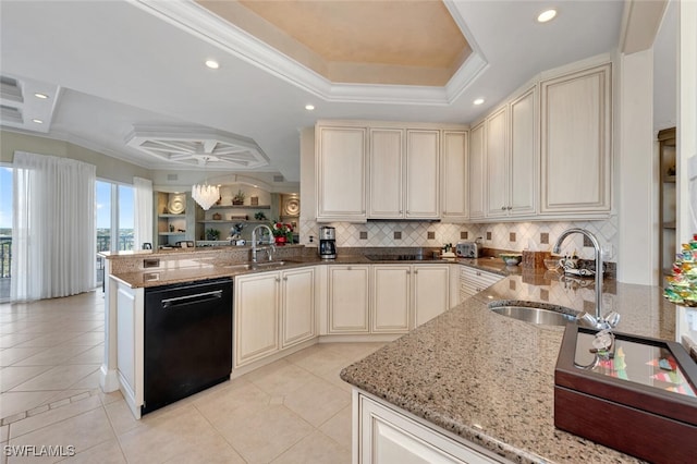 kitchen with a raised ceiling, black appliances, cream cabinets, and a sink