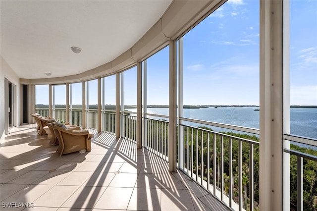 unfurnished sunroom with a water view and a wealth of natural light