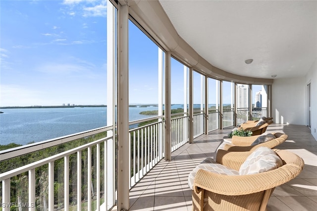 sunroom with a water view and a wealth of natural light