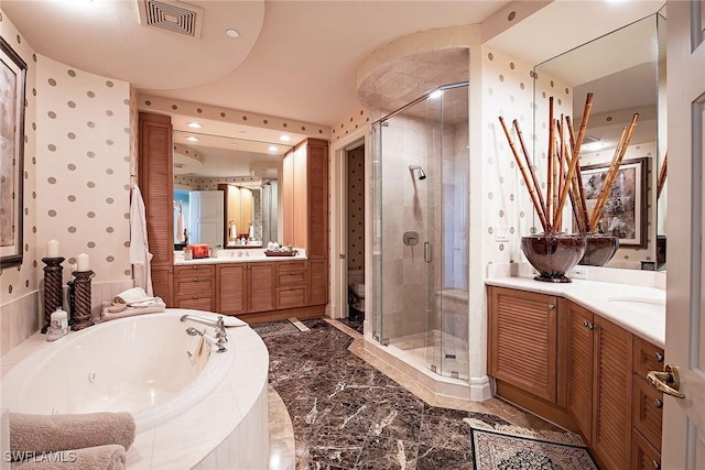 full bathroom featuring vanity, shower with separate bathtub, and toilet