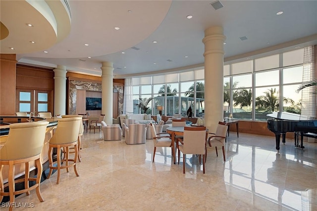 dining room featuring ornate columns