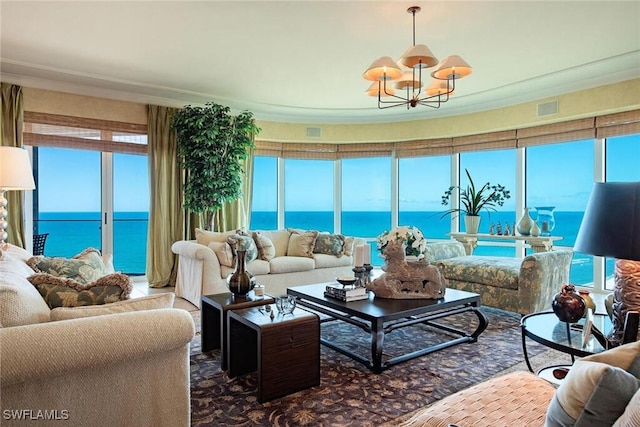 sunroom / solarium featuring a water view, plenty of natural light, and a notable chandelier