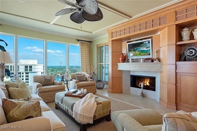 living room with light tile patterned floors, crown molding, and ceiling fan