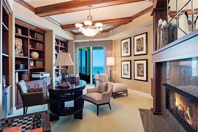 living area with carpet, a notable chandelier, a premium fireplace, a water view, and beam ceiling