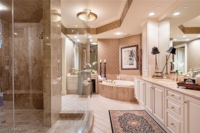 bathroom featuring vanity, ornamental molding, and independent shower and bath