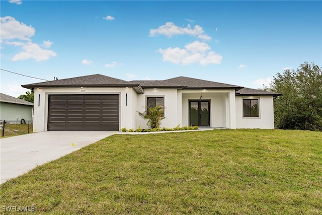 view of front of property with a garage and a front lawn