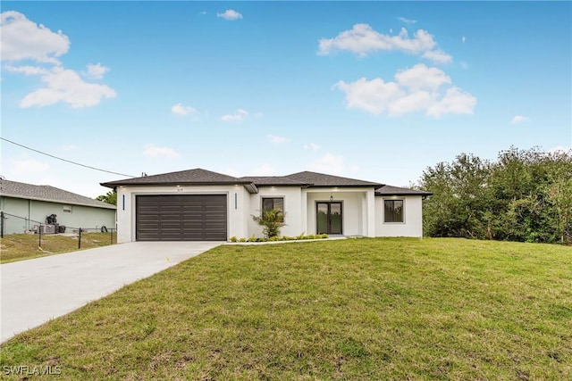 view of front of property with a front yard and a garage