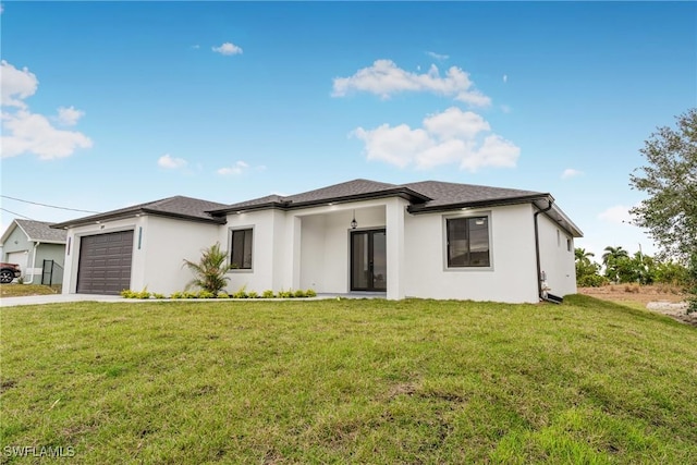 view of front of property with a front lawn and a garage