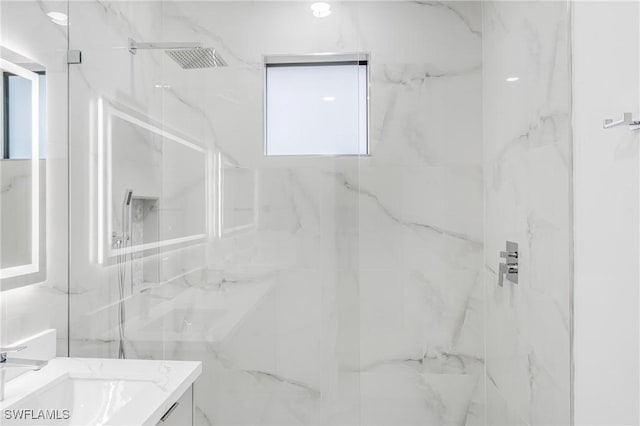 bathroom with vanity and tiled shower