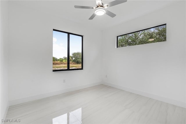 empty room featuring ceiling fan and a healthy amount of sunlight