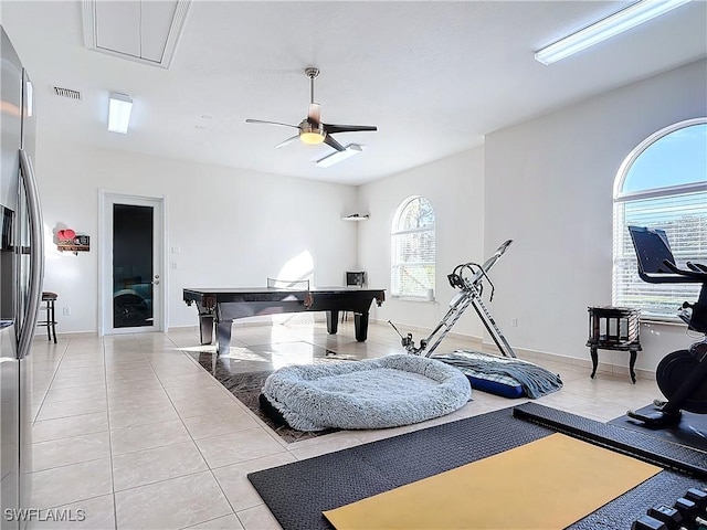 interior space with light tile patterned floors and ceiling fan