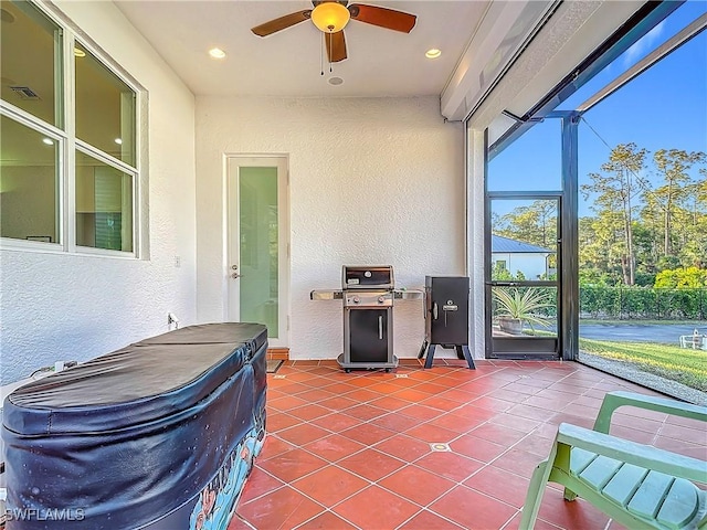 sunroom / solarium featuring ceiling fan