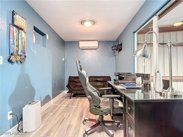 office area with a wall unit AC and light hardwood / wood-style flooring