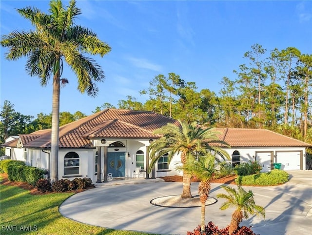 mediterranean / spanish-style house with a garage