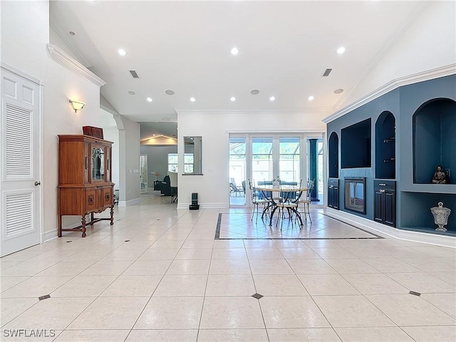 tiled dining space featuring crown molding, lofted ceiling, and built in shelves