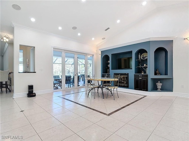 dining area with light tile patterned flooring, built in features, crown molding, and french doors