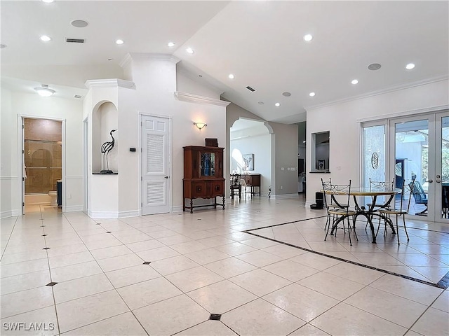 dining area with light tile patterned flooring, crown molding, and high vaulted ceiling